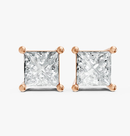 Two princess cut lab-grown diamond stud earrings set in rose gold plated prongs on a white background. Showcasing elegance, luxury, and bright sparkle.