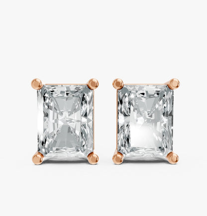 Pair of radiant-cut lab-grown diamond stud earrings set in rose gold plated prongs. Against a white background, reflecting elegance and simplicity.