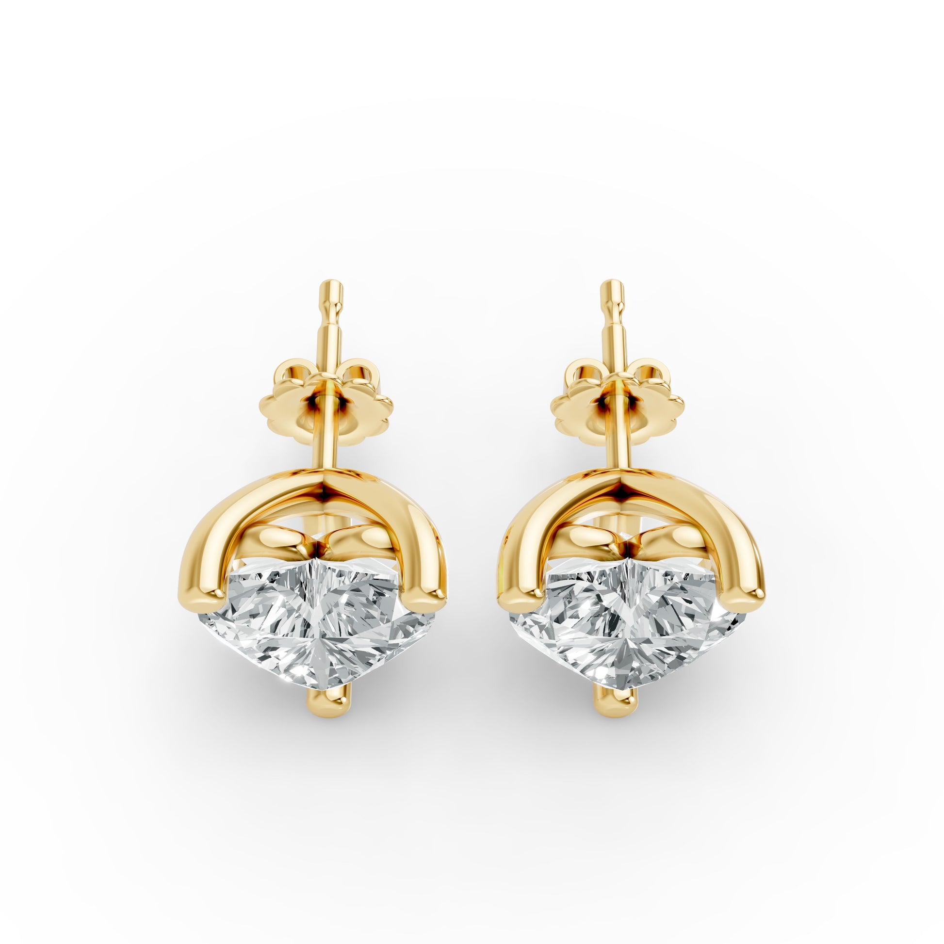 Elegant stud earrings featuring large, heart shape diamonds set in shiny gold plated prongs. Conveys luxury and sophistication.